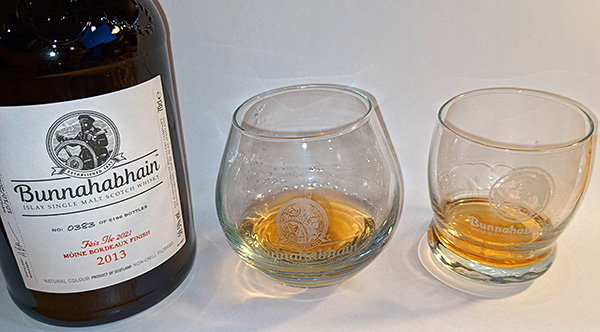 Picture of a bottle of Bunnahabhain Islay single malt whisky with two different wobbly glasses