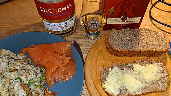 Picture of a brunch with scrambled eggs, smoked salmon and fresh bread as well as a dram of Kilchoman Islay single malt whisky