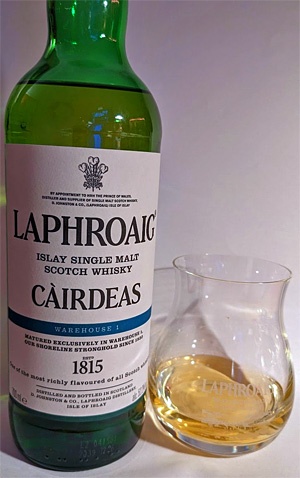 Picture of a bottle and a dram of Laphroaig Càirdeas 2022 Warehouse 1 Islay single malt whisky