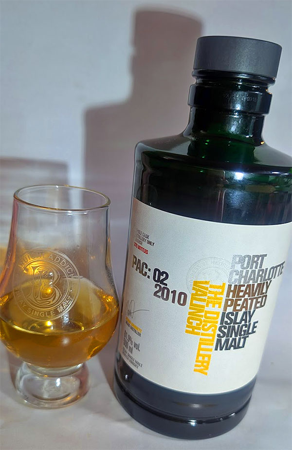 Picture of a dram and a bottle of PAC: 02 2010 The Distillery Valinch Port Charlotte Heavily Peated Islay Single Malt whisky